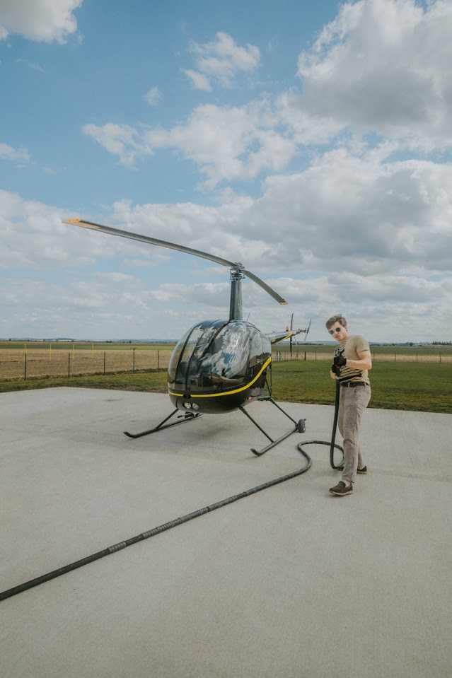 The pilot refuelling the helicopter